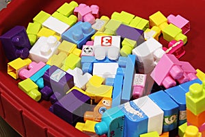 Colorful baby building blocks in a wagon