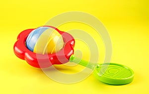 Colorful Baby Rattle on Yellow Background