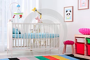 Colorful baby room interior with crib