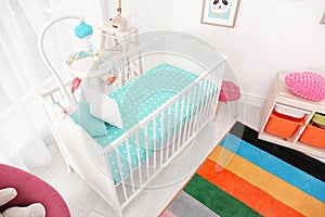 Colorful baby room interior with crib