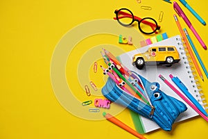 Colorful Back to School concept - office and student supplies on yellow background. Space for text