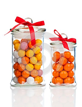 Colorful background of assorted Gumballs in glass jar photo