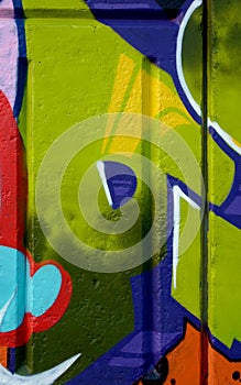 Colorful background of graffiti painting artwork with bright aerosol outlines on wall. Old school street art piece made