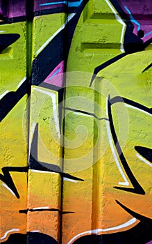 Colorful background of graffiti painting artwork with bright aerosol outlines on wall. Old school street art piece made