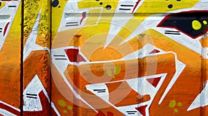 Colorful background of graffiti painting artwork with bright aerosol outlines on wall. Old school street art piece made