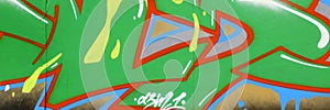 Colorful background of graffiti painting artwork with bright aerosol outlines on wall. Old school street art piece made