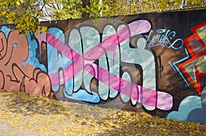 Colorful background of graffiti painting artwork with bright aerosol outlines on wall. Old school street art piece made