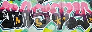 Colorful background of graffiti painting artwork with bright aerosol outlines on wall. Old school street art piece made