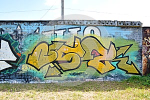 Colorful background of graffiti painting artwork with bright aerosol outlines on wall. Old school street art piece made