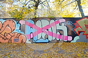 Colorful background of graffiti painting artwork with bright aerosol outlines on wall. Old school street art piece made