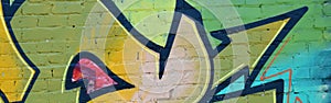 Colorful background of graffiti painting artwork with bright aerosol outlines on wall. Old school street art piece made