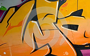 Colorful background of graffiti painting artwork with bright aerosol outlines on wall. Old school street art piece made