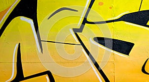 Colorful background of graffiti painting artwork with bright aerosol outlines on wall. Old school street art piece made