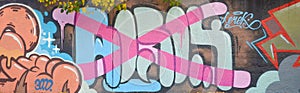 Colorful background of graffiti painting artwork with bright aerosol outlines on wall. Old school street art piece made