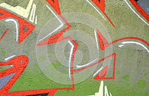 Colorful background of graffiti painting artwork with bright aerosol outlines on wall. Old school street art piece made