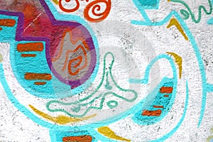 Colorful background of graffiti painting artwork with bright aerosol outlines on wall. Old school street art piece made