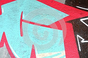 Colorful background of graffiti painting artwork with bright aerosol outlines on wall. Old school street art piece made