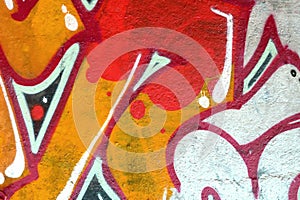 Colorful background of graffiti painting artwork with bright aerosol outlines on wall. Old school street art piece made