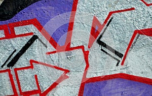 Colorful background of graffiti painting artwork with bright aerosol outlines on wall. Old school street art piece made