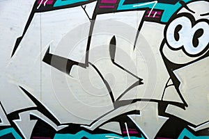 Colorful background of graffiti painting artwork with bright aerosol outlines on wall. Old school street art piece made