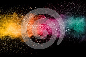 Colorful background of pastel powder explosion.Rainbow color dust splash on black background