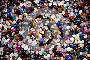 Colorful background with small stones. Abstract background with colored rocks. Shiny precious small stones background. Closeup ima