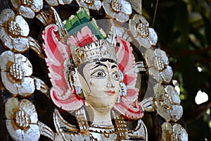 Colorful balinese wooden statue of hinduistic goddess