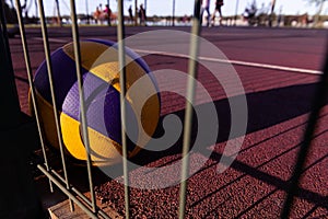 Colorful ball laying on the red ground at the sunset.