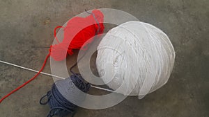 Colorful ball of threads wool yarn for knitting on grey floor background