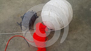 Colorful ball of threads wool yarn for knitting on grey floor background