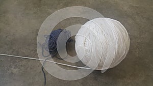 Colorful ball of threads wool yarn for knitting on grey floor background