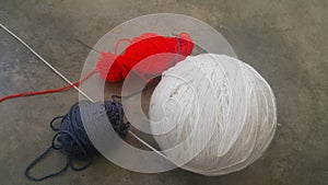 Colorful ball of threads wool yarn for knitting on grey floor background