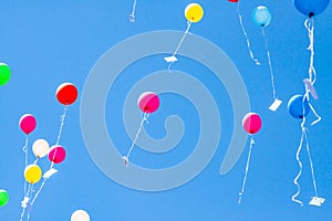 Colorful ballons with letters flying in the blue sky