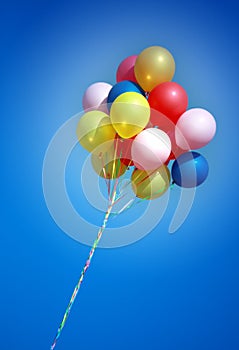 Colorful balloons in blue sky photo