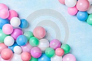 Colorful balloons on blue table top view. Birthday or party background. Flat lay style