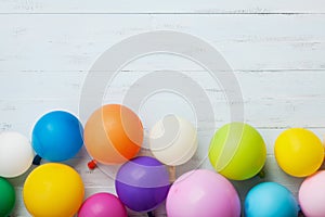 Colorful balloons on blue wooden table top view. Birthday or party background. Flat lay style. Copy space for text. Greeting card.