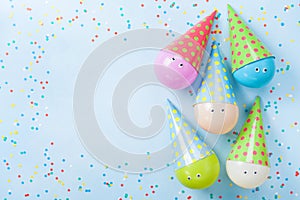 Colorful balloons and confetti on blue table top view. Birthday or party background. Flat lay. Greeting card.