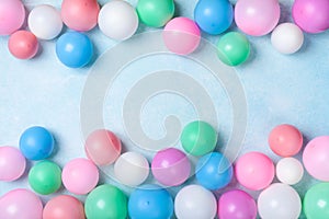 Colorful balloons frame on blue table top view. Festive or party background. Flat lay style. Birthday greeting card