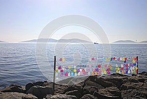 Colorful balloons with stones and sea on the background