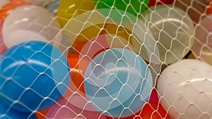 Colorful balloons in white net