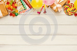 Colorful balloons on white rustic wood, birthday background, top