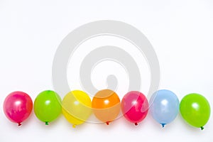 Colorful balloons on white wall or table top view. Festive or party background. Flat lay style. Copyspace for text