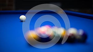 Colorful balls on a blue pool table. Set up and ready to play. Selective focus