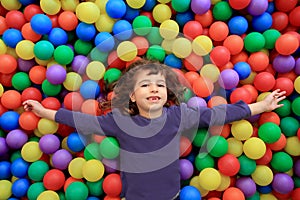 Colorful balls funny park little girl lying