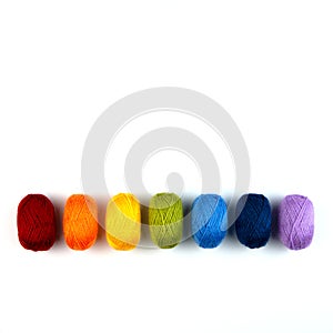 Colorful balls of wool in a row. Closeup.