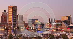 Colorful Baltimore skyline over the Inner Harbor at dusk