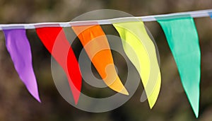 A colorful banner with flags hanging from a string