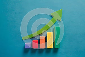 Colorful bar chart with green arrow pointing upward, representing growth in values