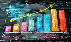 Colorful Bar Graph with Rising Arrow Indicating Growth, Progress and Success on a Blackboard, Symbolizing Business Analysis