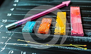 Colorful Bar Graph with Rising Arrow Indicating Growth, Progress and Success on a Blackboard, Symbolizing Business Analysis